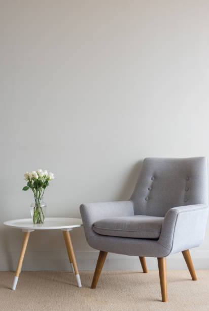 istock Retro armchair with roses on table against wall 913883044