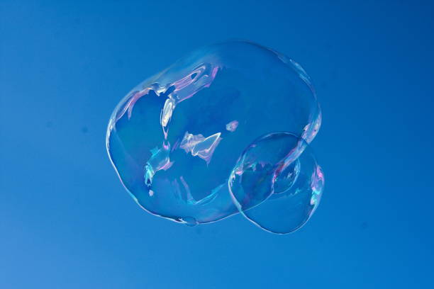 istock Colorful raindow soap bubble on blue background 913883748