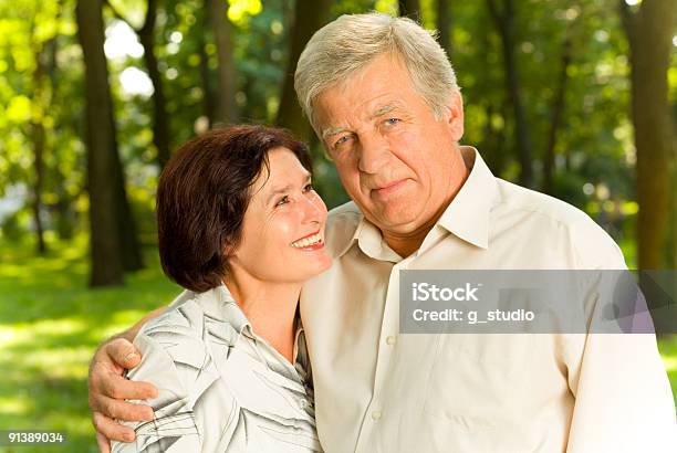 Senior Attractive Happy Couple Embracing In Park Stock Photo - Download Image Now - Active Lifestyle, Active Seniors, Activity