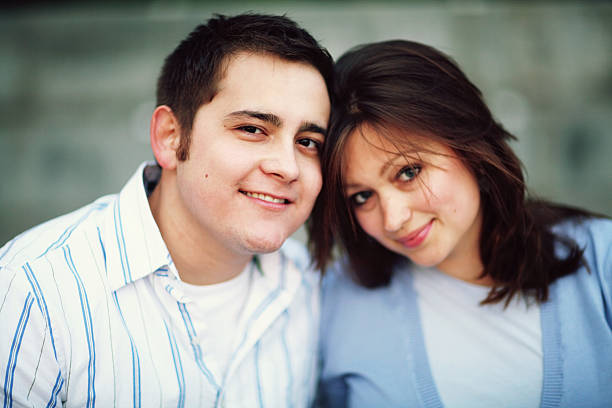 istock Dark Haired Couple Resting Heads on Each Other 91389043