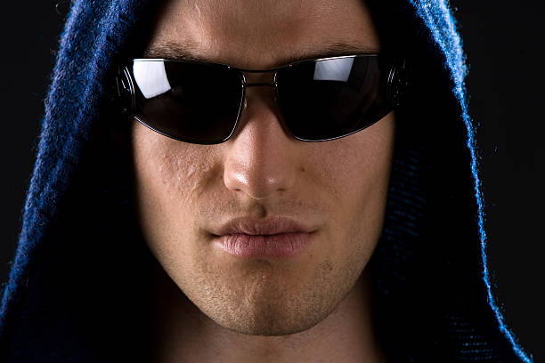 Vertical closeup portrait of young Asian woman wearing cyberpunk style sunglasses in futuristic set