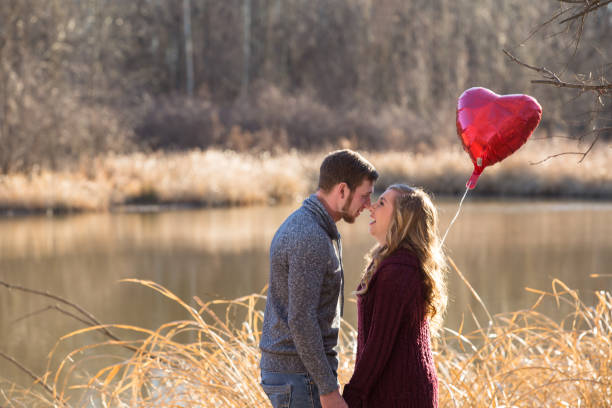 istock Attractive couple holding hands, kissing,smiling 913898302
