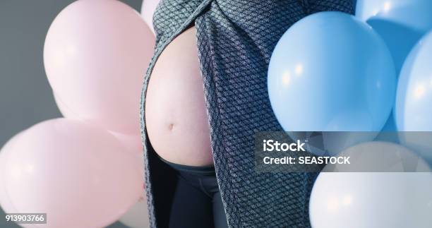 Close Up Pregnant Belly Baby Bump Girl Boy Pink Blue Colored Balloons Celebration Shower Reveal Annoucement Concept Motherhood Maternity Life Stock Photo - Download Image Now