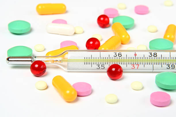 thermometer and pills stock photo