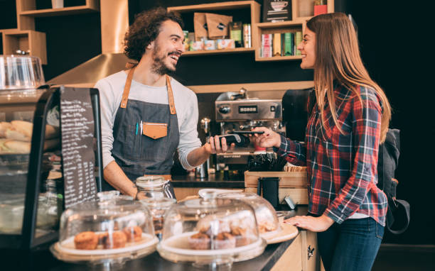 istock Customer paying via smart phoone at a coffee shop 913912222