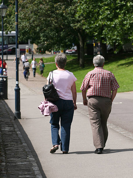 istock Retired middle-aged couple walking in park on sunny day 91391807