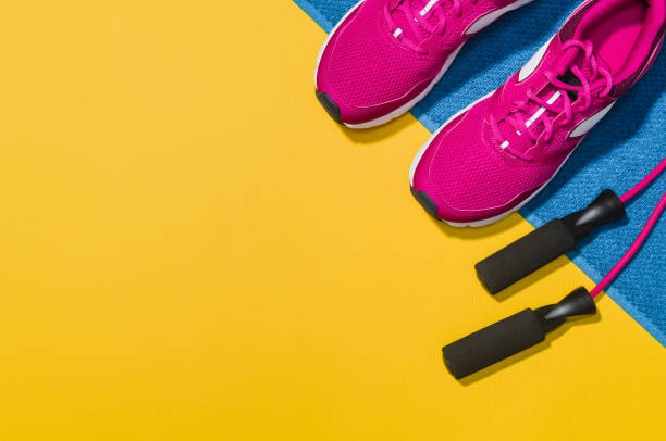 istock Fitness accessories on yellow background mock up, top view 913935560