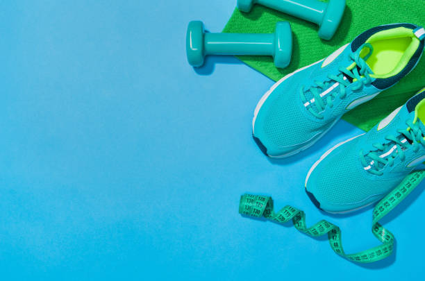 istock Fitness accessories on blue background mock up, top view 913935598