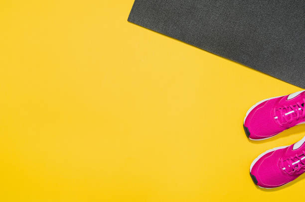 istock Fitness accessories on yellow background mock up, top view 913935710
