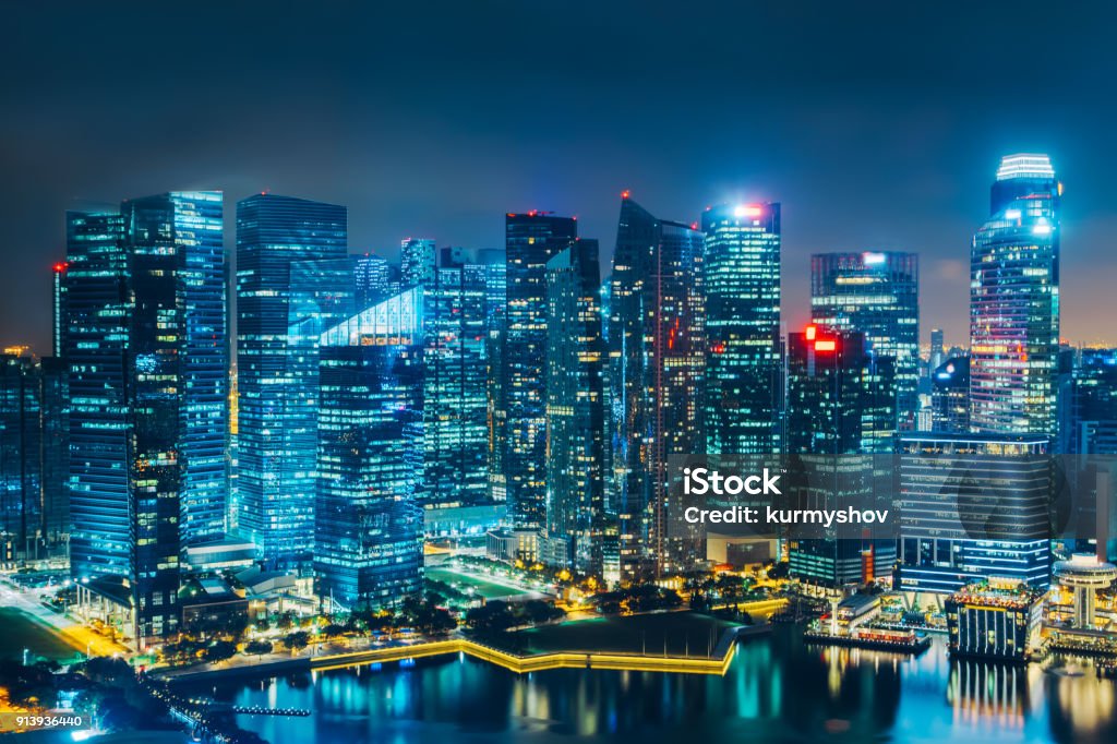 Singapore city skyline. Business district aerial view. Downtown landscape reflected in water at night in Marina Bay. Travel cityscape Singapore Stock Photo