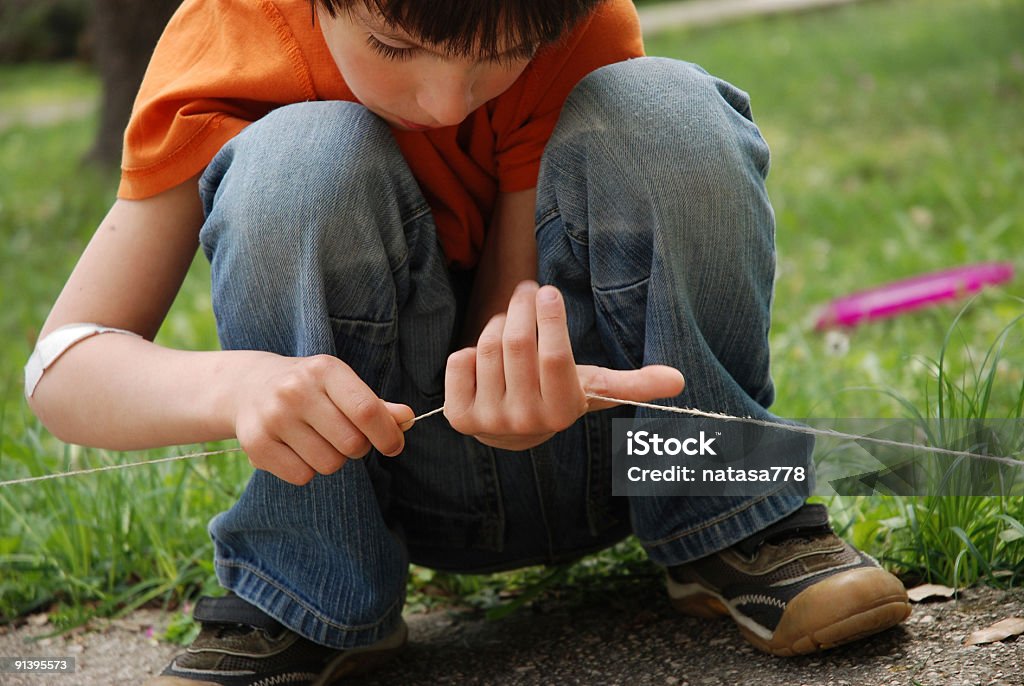 Little boy playing with string  Autism Stock Photo