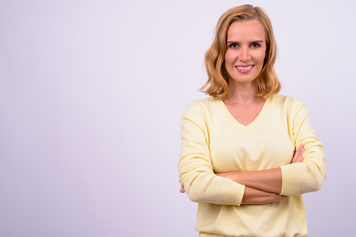 Studio Shot Of Beautiful Blonde Woman Against White Background