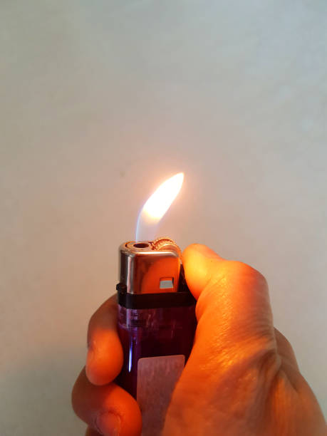 istock Lighter on hand, the woman use lighter on white wall in the room for making bright 913961302