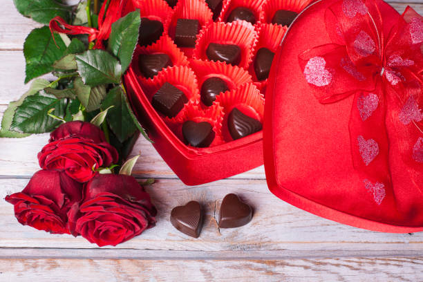 istock Heart chocolate box and red roses on wooden rustic background 913962470