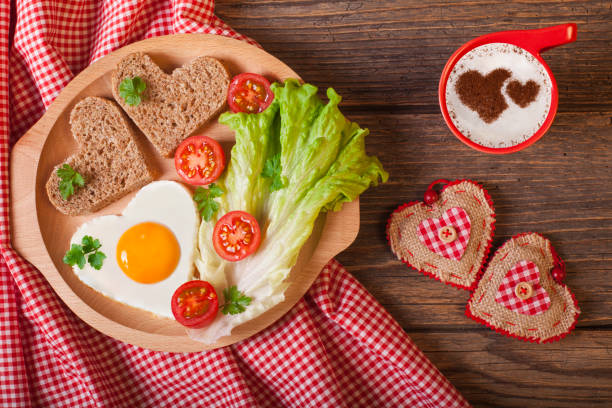 petit déjeuner le jour de la saint-valentin sur une table en bois rustique. - fried egg lettuce vegetable lunch photos et images de collection