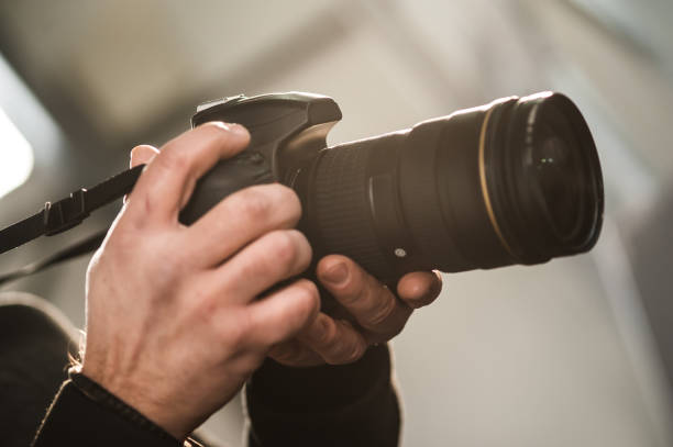 istock Man hand holding camera and take the photo 913968754