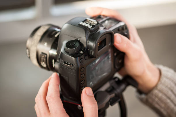 istock Man hand holding camera and take the photo 913969030