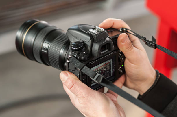 istock Man hand holding camera and take the photo 913969096