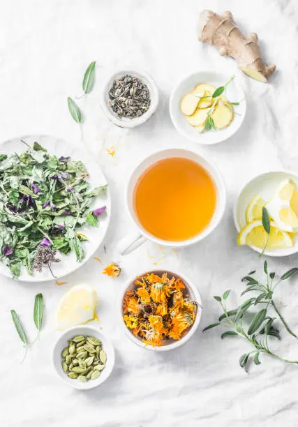 Flat lay liver detox antioxidant tea and the ingredients for it on a light background, top view. Herbal homeopathic recept