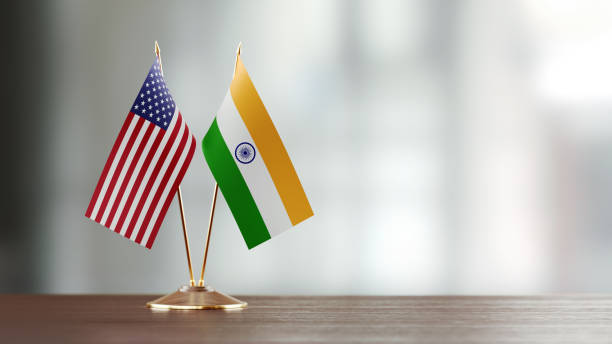 American And Indian Flag Pair On A Desk Over Defocused Background