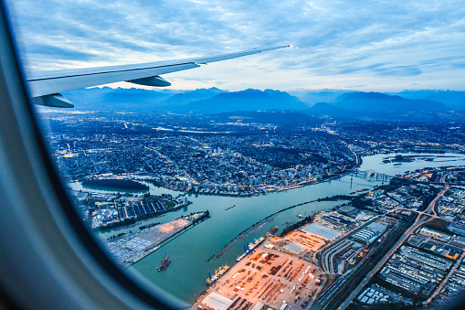 View from airplane window on fields in wing with top view of Vancouver,Canada