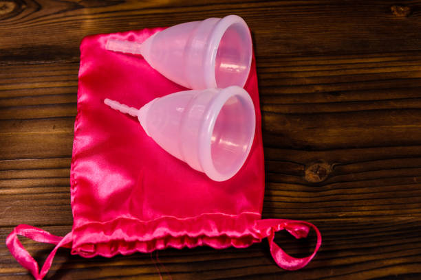 istock Two menstrual cups and cotton bag on a wooden table 913984454