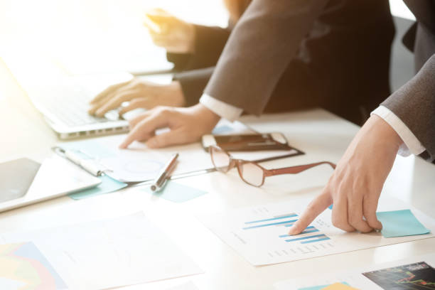 istock business analysis hands pointing data paper and consulting with closeup. 913987592