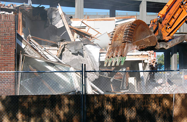 istock Crane with rake attachment demolishing building 91399232