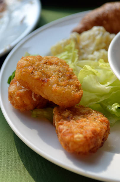istock chicken nuggets and vegetable salad on a white plate 913995658