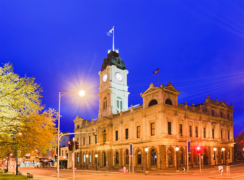Town hall in regional town of Ballarat, Victoria. Sunrise agains blue sky with bright illumination of this historic architecture of gold rush region.