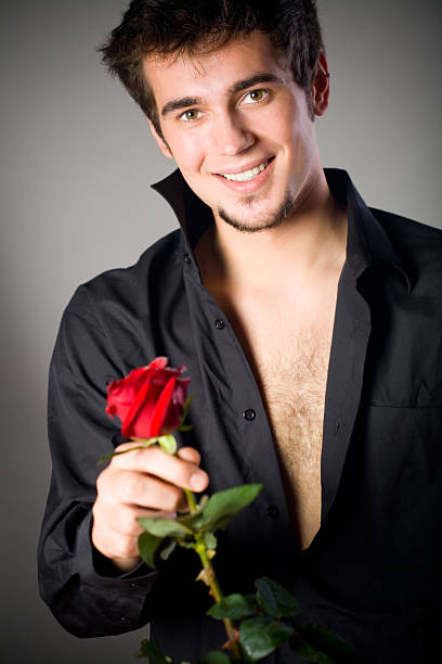 istock Young happy smiling handsome man with rose, dark tone 91400090