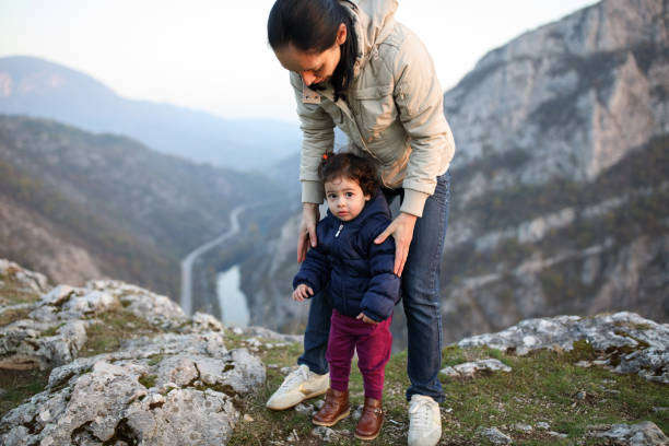 istock Mother and daughter on mountain top 914002606