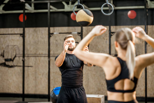 istock Young couple training with ball in the gym 914003084