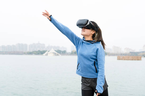 istock woman exercising in nature with VR glasses 914004214