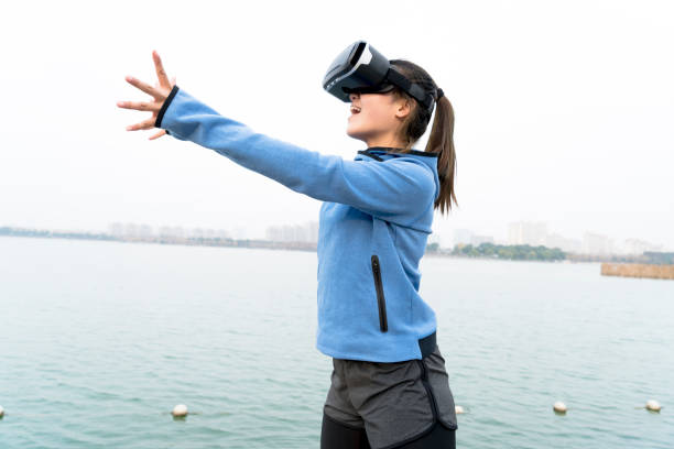 istock woman exercising in nature with VR glasses 914004224