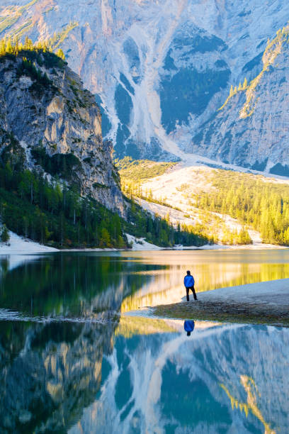 istock Man Traveler standing alone  Braies Lake 914006710