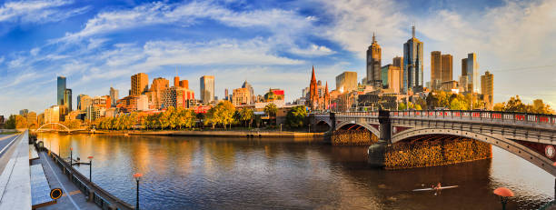 Me CBD Yarra Light pan From southbank across yarra river looking at Melbourne city CBD landmarks on a sunny summer morning under blue sky. south yarra stock pictures, royalty-free photos & images