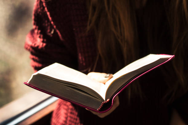 istock woman holding and reading bible 914007196