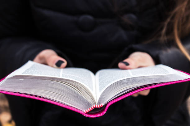 istock woman holding and reading bible 914007340
