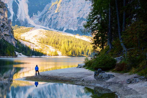 istock Man Traveler standing alone  Braies Lake 914011304