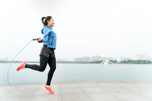 istock young woman skipping at lakeshore 914015968
