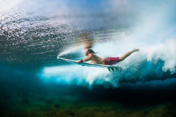 istock Young surfer dives under the ocean wave 914016184