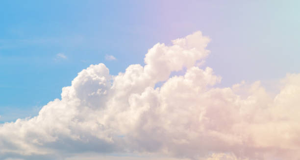 istock White cloud on blue sky. Cloudscape photo background. Romantic skyscape with cloud and pink sun flare. 914017830