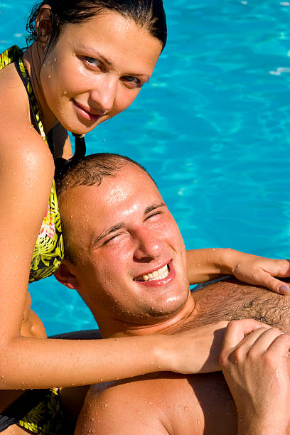 istock attractive couple relaxing by the pool 91402185