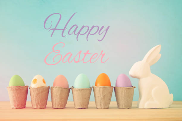 istock Cute bunny next to easter colorful eggs over colorful background. 914029856