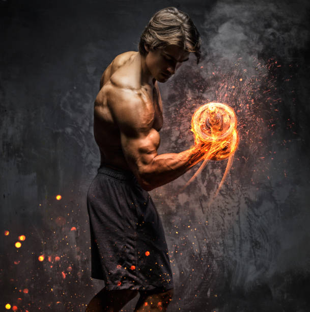 Portrait of a man with burning dumbbell. stock photo