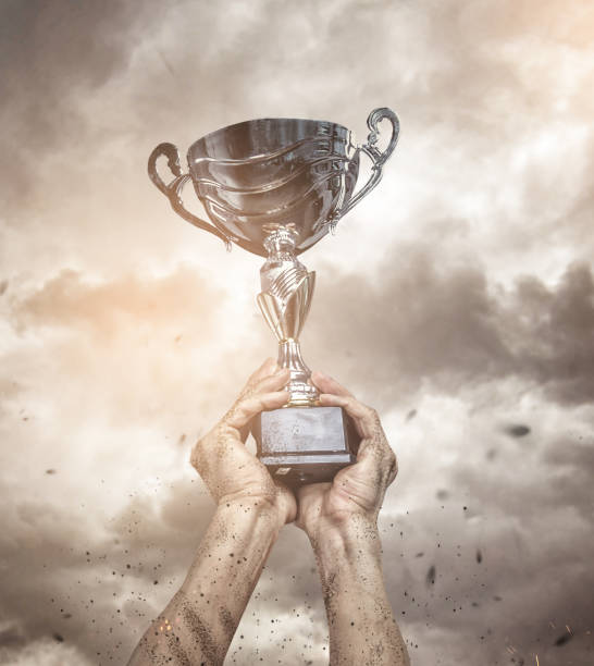 istock Cropped male arms with winner cup. 914030972