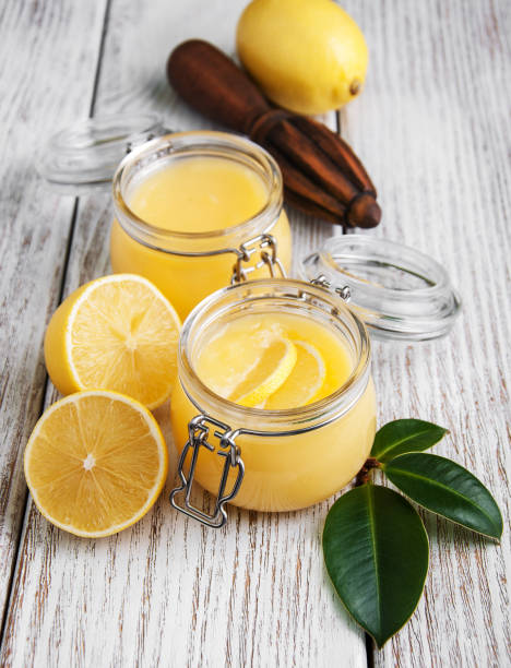 istock Lemon curd in glass jar with fresh lemons 914034190