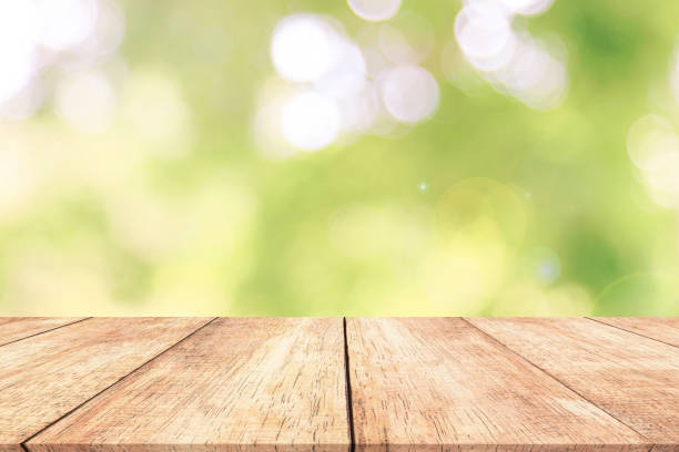 istock Wood table top on blur nature background with spring or summer 914034246