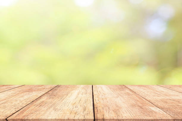 istock Wood table top on blur nature background with spring or summer 914034302